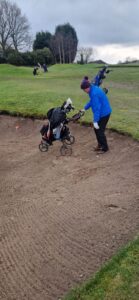 Phil Mac Raking Bunker With His Trolley